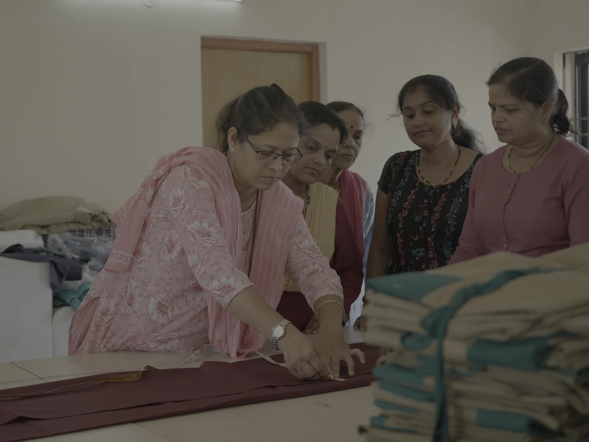 Women learning and working with fabric at Mahila Bhavan